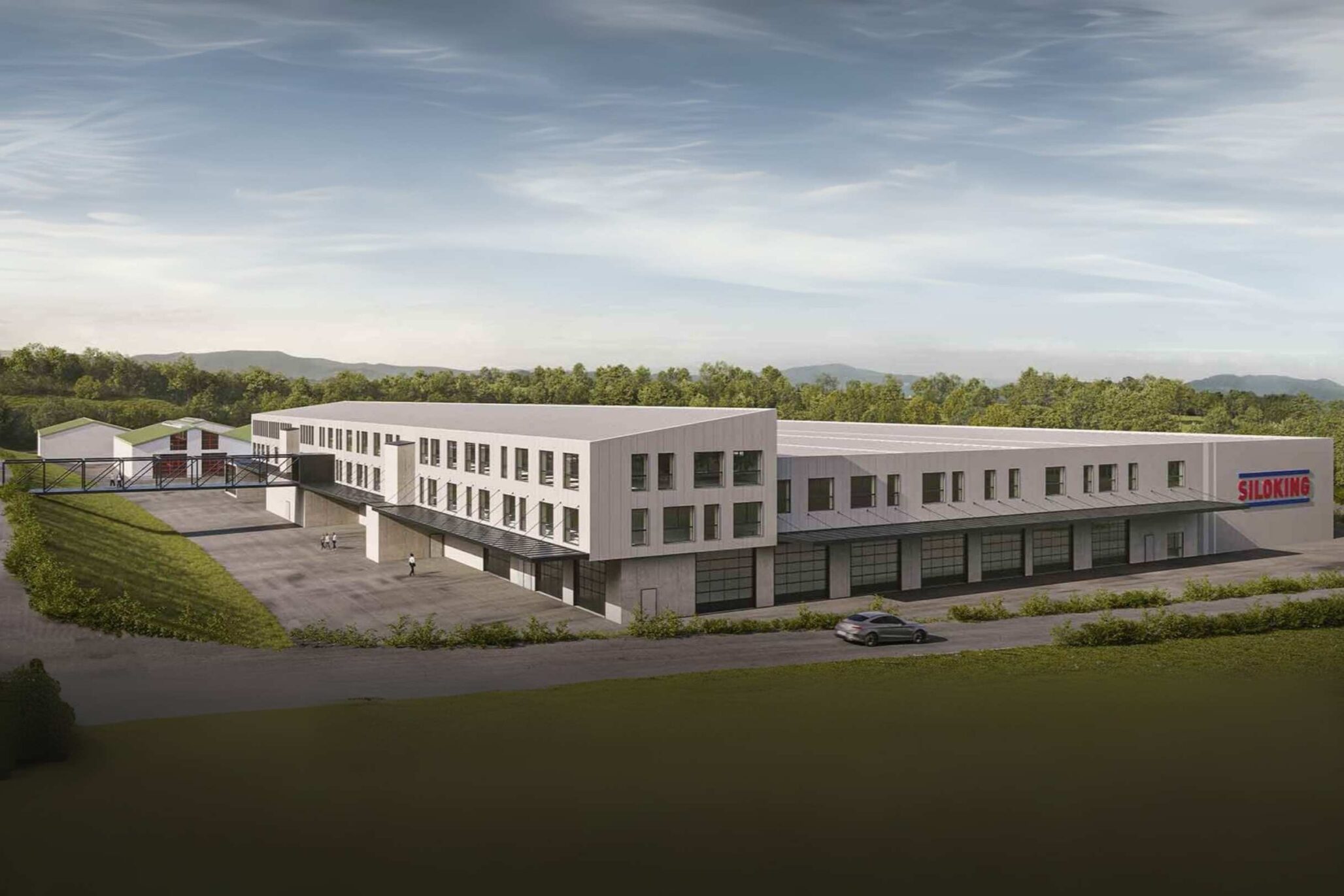 Moderne Industrie- und Bürogebäude der Firma SILOKING in Randlage mit großzügigem Vorplatz, umgeben von Natur und bewaldeter Hügellandschaft.